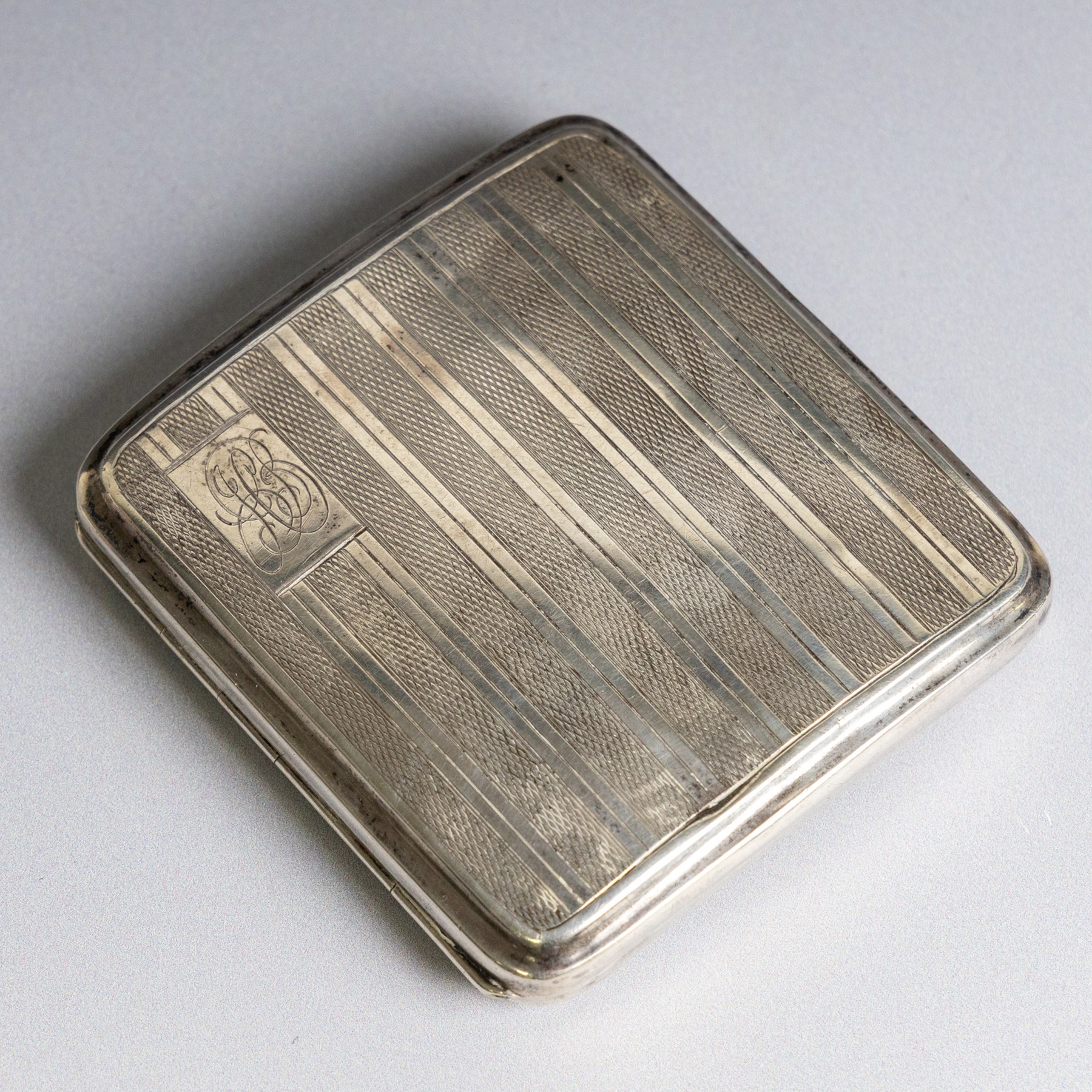 1920s silver cigarette case, with engine turned decoration and engraved monogram, hallmarked John Henry Wynn, Birmingham 1929