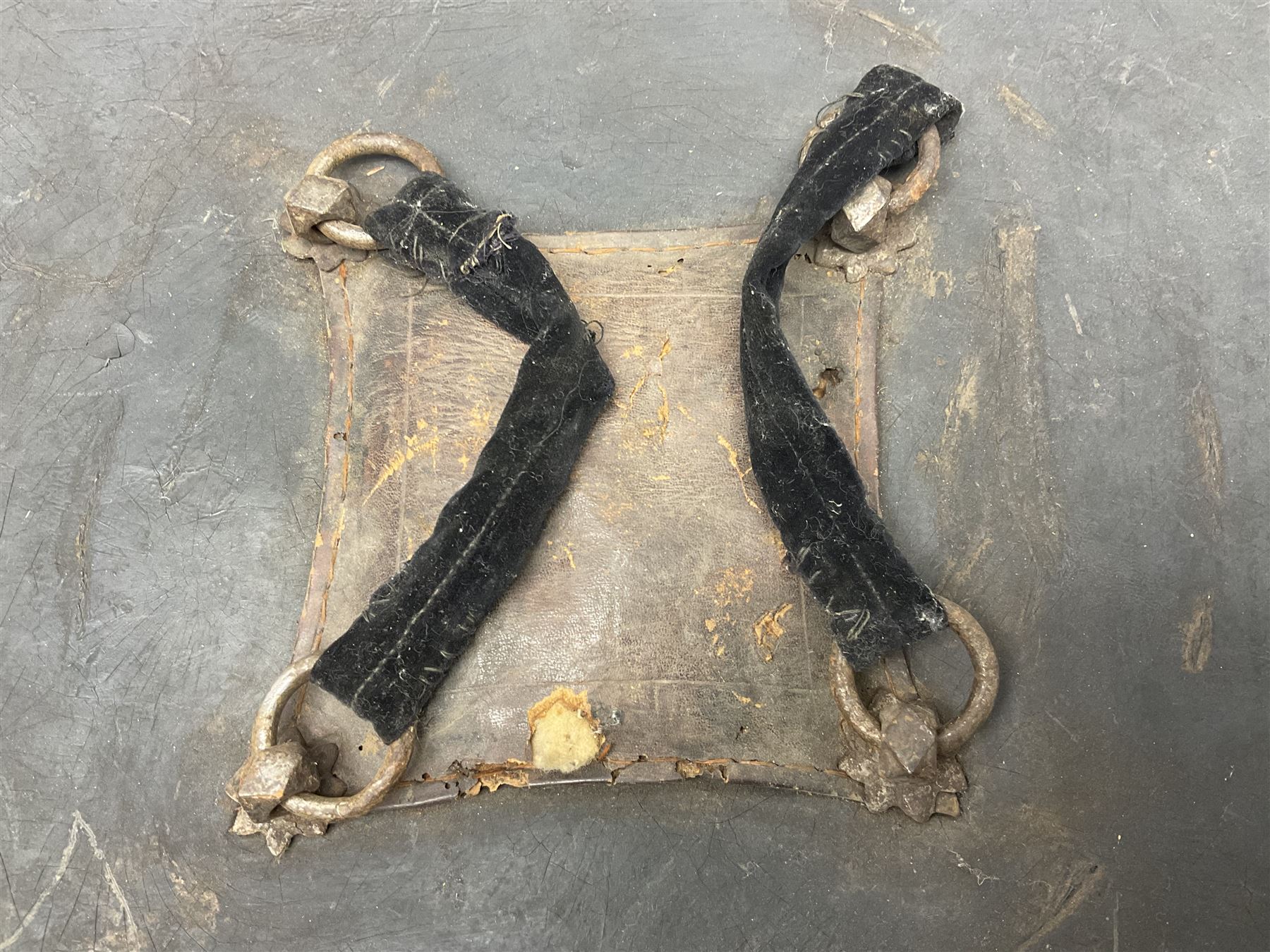 Indian black lacquered hide shield/dhal, of circular convex form fitted at its centre with four pierced iron bosses, each of hemispherical form with wide brims, the bosses corresponding on the inside with four iron rings for enarmes D53.5cm