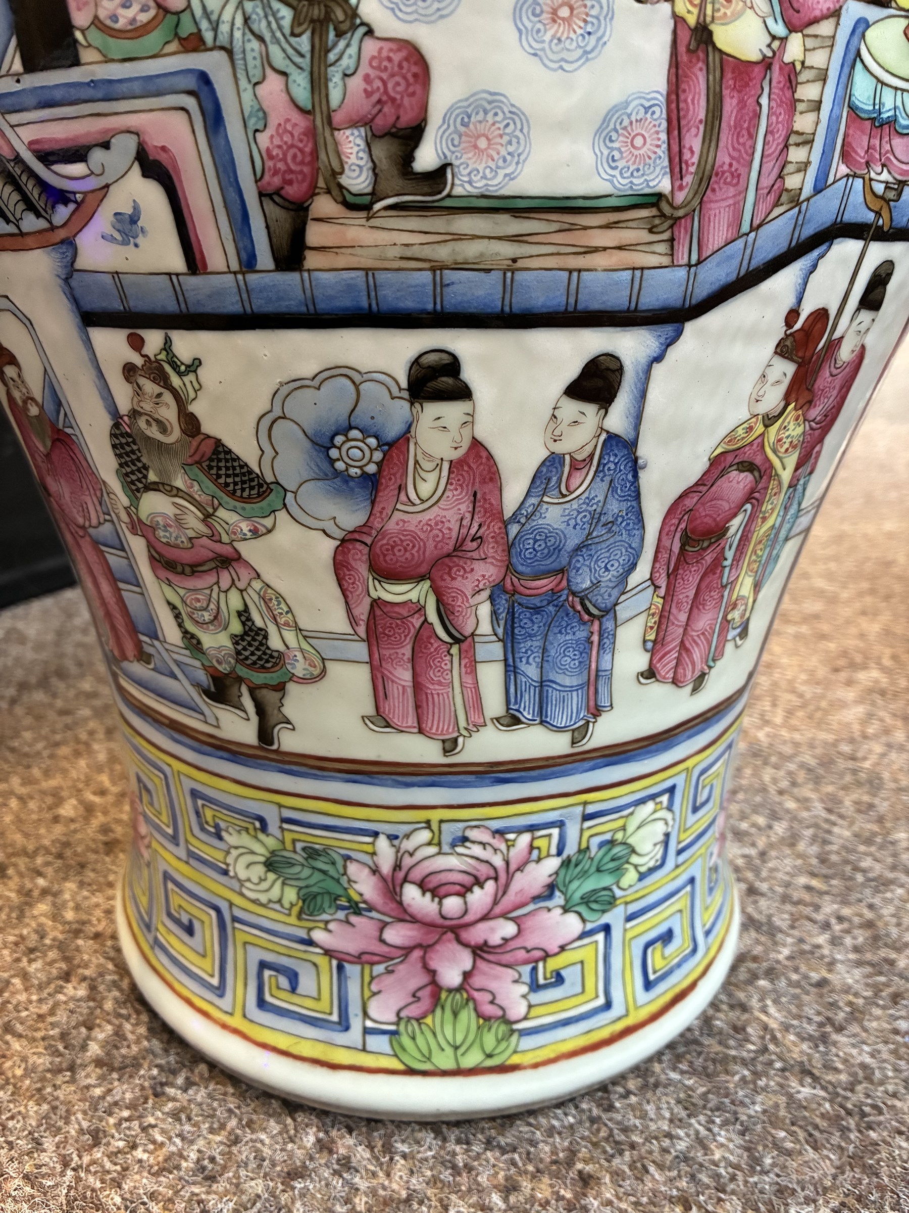 Large pair of 19th century Cantonese famille rose vases, each painted with various courtly scenes, including a display of warriors fighting on horseback before an official and his attendants, double Buddhist lion handles and applied at the shoulders with chilong, the lower band painted with Greek key motif, H58cm (2)