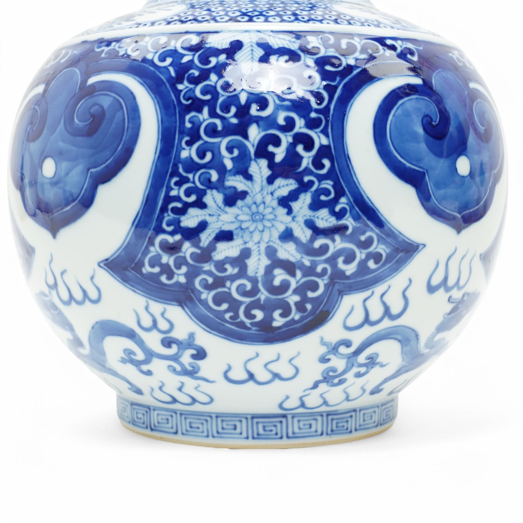 Late Qing Dynasty bottle vase decorated in blue and white with dragons and pearls, stylised leaves and flowers with key pattern foot H40cm 