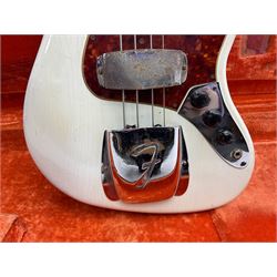 1963 Fender Jazz three-knob bass guitar; impressed with date code 7AUG63A on end of neck and serial no.L08587 on back plate; all original but re-finished in white in the 1970s; sold with photographs of the instrument in the 1960s with original finish and in the 1970s re-finished; L117.5cm; in original hard carrying case; Provenance: the professional guitar of Howard Livett from new to his death in 2005. Howard played in The Humperdincks, the backing group for Englebert Humperdinck, also played in the backing group for Max Bygraves and in the band Hedgehoppers Anonymous. The guitar is also sold with a manuscript letter of provenance from Howard's wife.