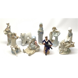 A mid 20th century Dresden porcelain figurine, modelled as a sailor playing an accordion, H16.5cm, together with a collection of seven Lladro figurines, to include a polar bear figure group. 