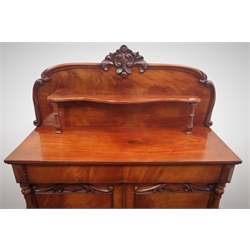  Victorian mahogany raised back chiffonier, floral carving above small display shelf, single frieze drawer above two cupboards on plinth base, W110cm, H147cm, D44cm  