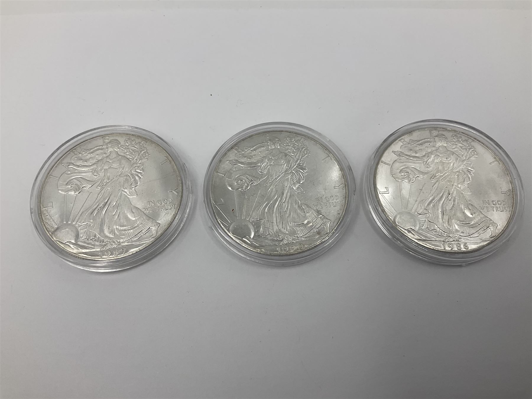 Five United States of America 1oz fine silver one dollar coins, dated 1986, 1987, 1988, 1989 and 1990