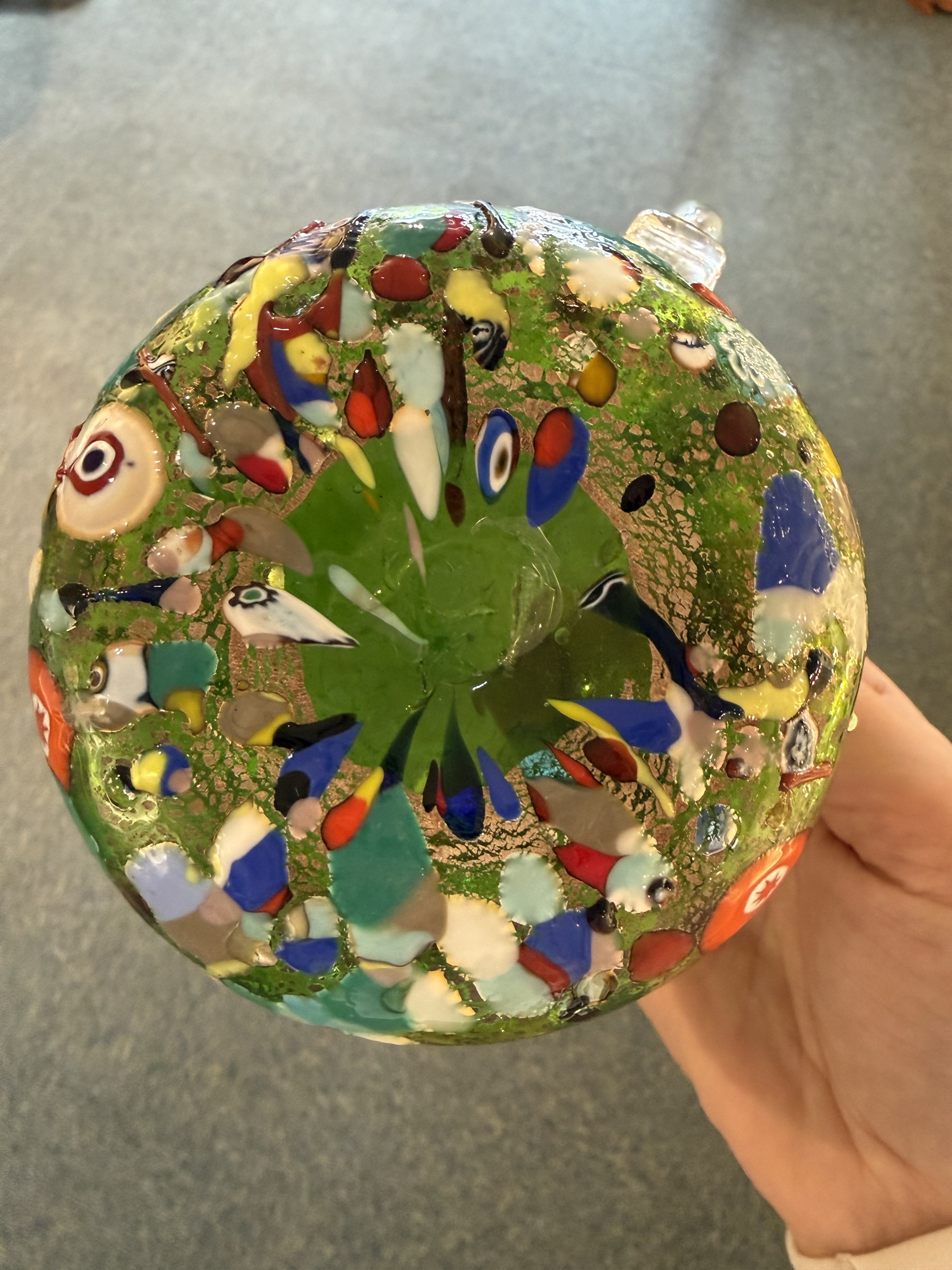 Two Murano Glass jugs by Zecchin, the fist decorated with millefiori design, upon a purple mottled ground, the other upon a green ground, H10cm