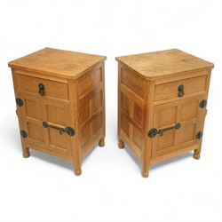 Beaverman - pair of oak bedside cabinets, each with plain rectangular top over single drawer and cupboard below with fielded panels and wrought iron hardware, with signature carved beaver, by the workshop of Colin Almack, Thirsk