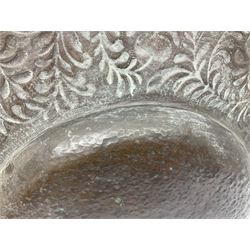 Arts and Crafts Keswick School of Industrial Arts copper charger, decorated with planished centre and repousse scrolling foliate tendrils to rim, D44cm