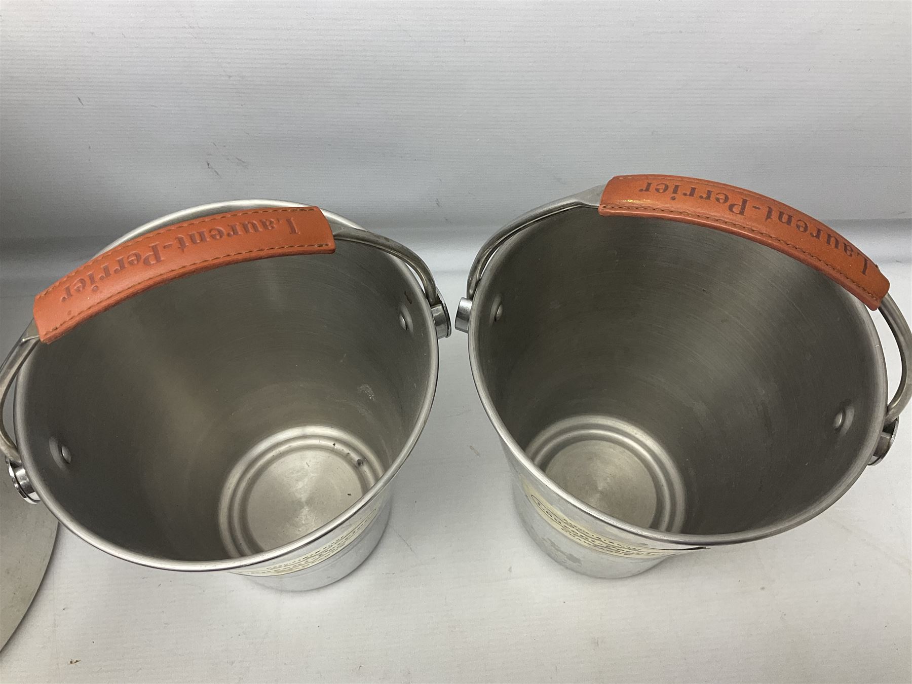 Stainless steel Laurent-Perrier champagne bucket, with engraved brass plaque and grip to swing handle, together with three matching smaller, largest D38cm (4)