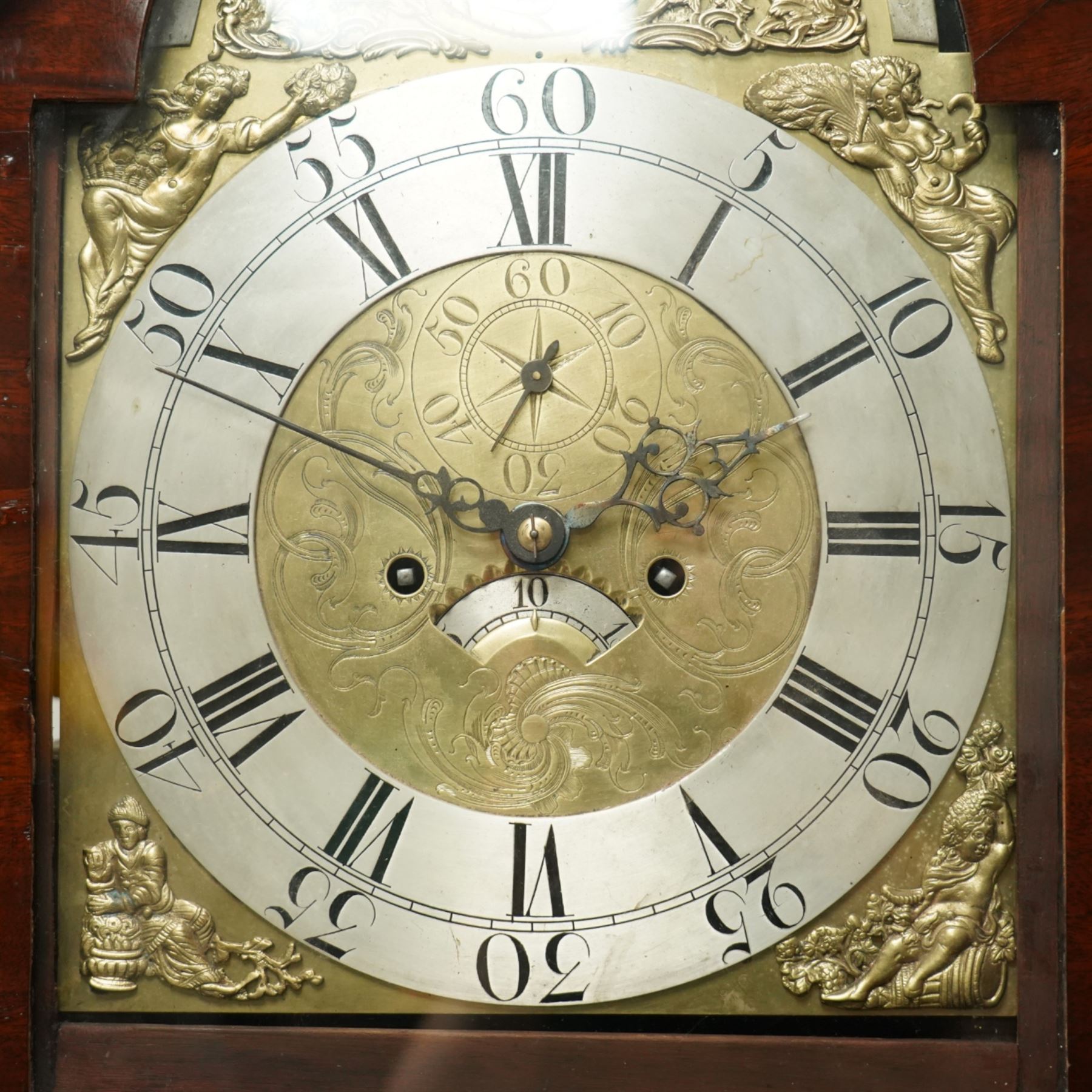 William Vise of Wisbech (Cambridgeshire)-8-day mahogany Longcase clock c1750, with a swan neck pediment and inlaid parterre, break arch hood door beneath flanked by detached reeded pilasters with brass capitals, trunk with conforming pilasters to the corners and an inlaid door with banding to the edge and oval satinwood inlay and matching conche inlay to the centre, conforming pediment with matching circular inlay and raised on bracket feet, brass break arch dial with interesting scroll and floral spandrels to the arch and four season spandrels to the corners, fully engraved dial centre with steel hands, engraved seconds dial and square date aperture, silvered boss to the arch with makers name and conforming chapter with Roman numerals, five minute Arabic's and minute track, dial pinned directly to a two train weight driven rack striking movement, sounding the hours on a bell. With weights and pendulum. 
Both a William and John Vise are recorded as working in Wisbech between 1740 and1758.