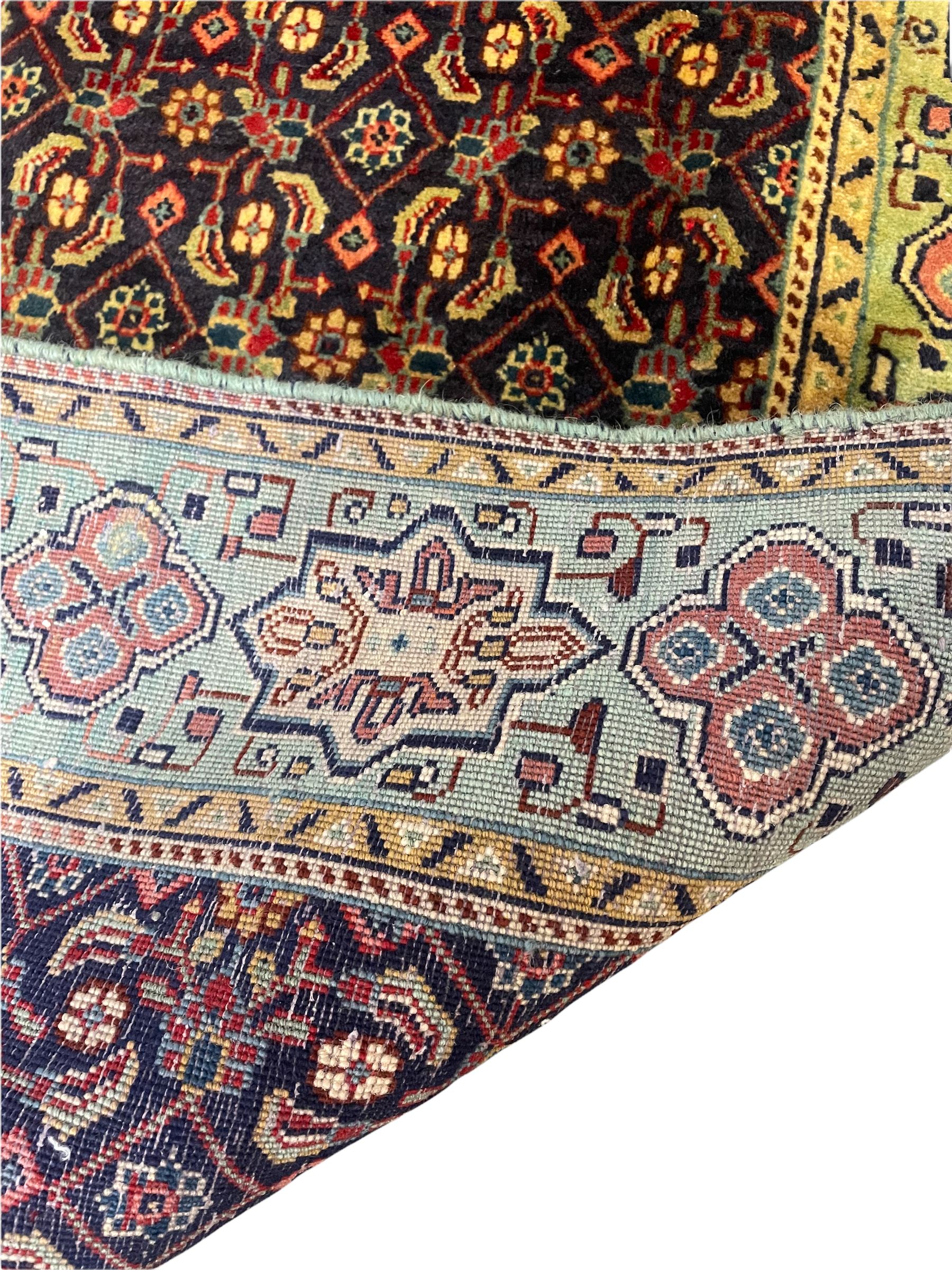 Persian Mahal rug, the blue ground field decorated with repeating Herati motifs, guarded pale ground border decorated with stylised panels