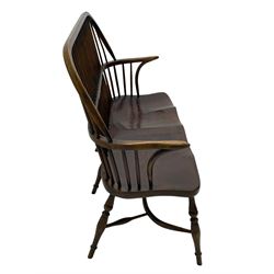 Traditional elm and oak two seat Windsor bench, high comb and stick back, double dished seat on turned supports joined by two crinoline stretchers