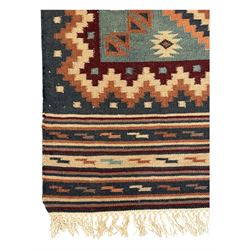 Flatweave rug, terracotta ground with multicoloured geometric diamond motifs, framed by a teal and burgundy border, finished with fringed edges