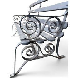 Coalbrookdale - rare pair of wrought iron and slatted wood garden benches, the twin wrought iron strapwork bench-ends formed of four scrolls over splayed feet, number 77 in the Coalbrookdale Castings Catalogue (see illustration)