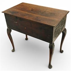 Early 20th century carved oak lowboy, rectangular moulded top above three short drawers carved with flowerhead panels and fitted with brass drop handles, shaped apron with foliate carving, raised on cabriole supports terminating in pad feet
