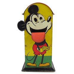 Saalheimer & Strauss Germany 'Smile Please' Mickey Mouse mechanical tin-plate money bank, Type I, depicting Mickey posing with folded hands on the front and as a photographer with a camera tripod on the reverse along with the motto 'If you only pull my ear you will see my tongue appear. Place a coin upon my tongue save your money while you're young'. H17.5cm