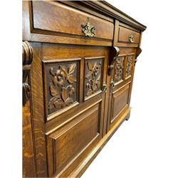 Edwardian oak mirror back sideboard, raised shaped pediment carved with acanthus leaves over Greek key frieze, bevelled mirror back, fitted with two drawers and two cupboards