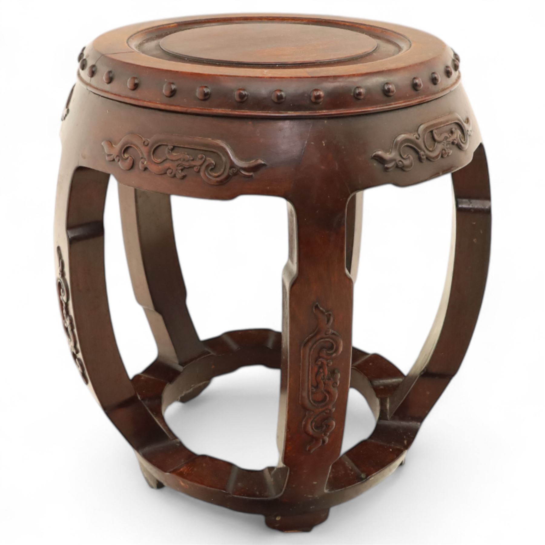 Pair of early 20th century Oriental hardwood barrel seats, of drum form with shaped apron and pierced panels, carved with stylised scrollwork and studded detail to the top