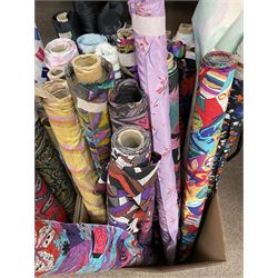 Haberdashery Shop Stock: Various rolls of fabric including a large roll of striped lining fabric, metallic printed stage satin, abstract and geometric patterns, children's and festive fabric, Paisley and others (qty) in two boxes 