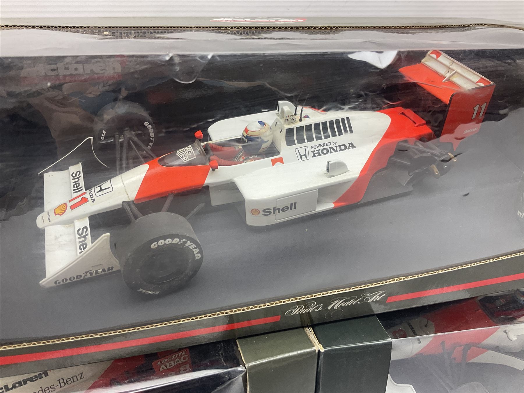 Three Paul's Model Art 1:18 scale die-cast McLaren racing cars - Mercedes MP4/11 D. Coulthard; MP4/4 A. Prost; and Mercedes MP4/10 M. Hakkinen; all boxed (3)