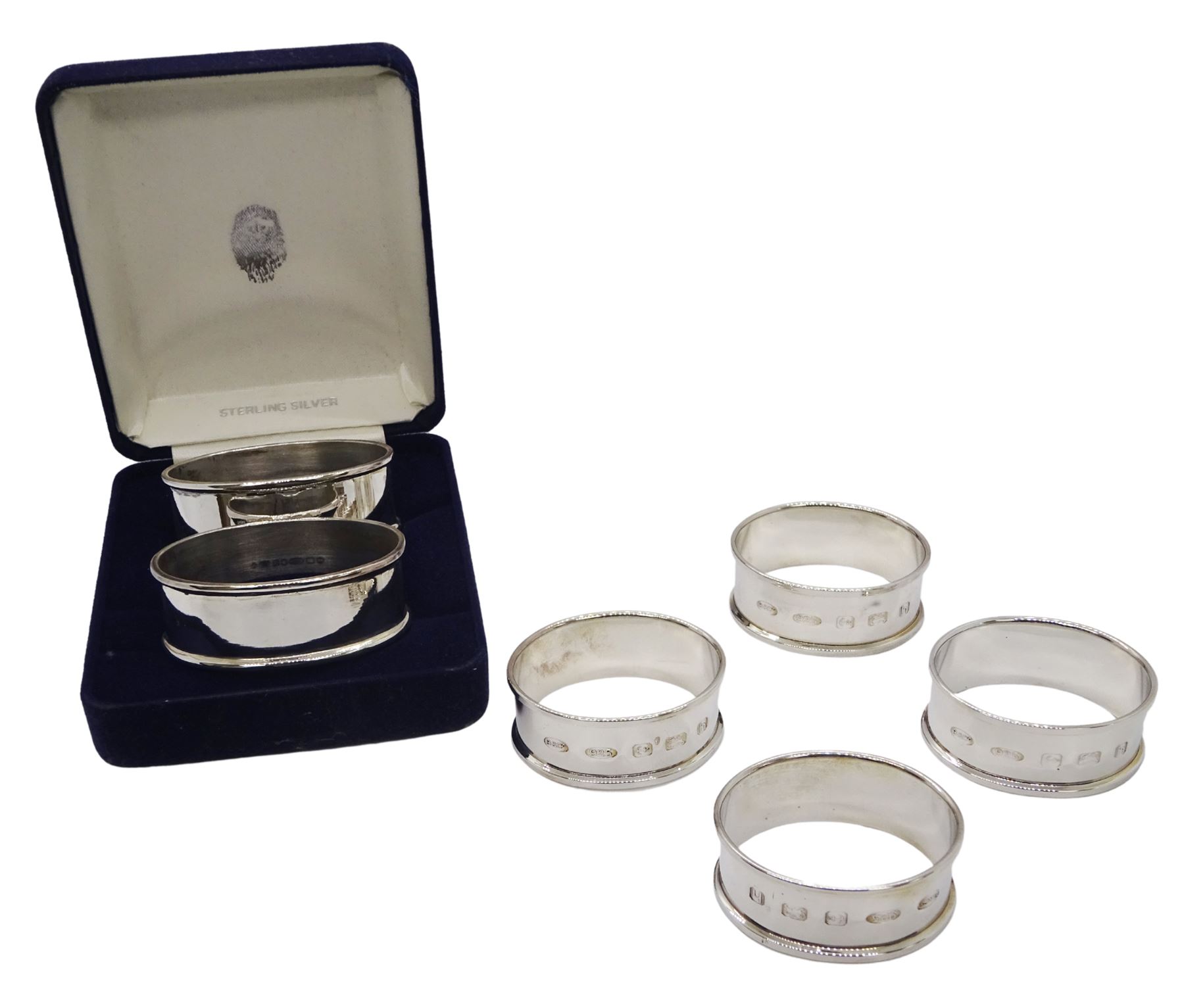 Set of four modern silver napkin rings, of plain oval form, hallmarked