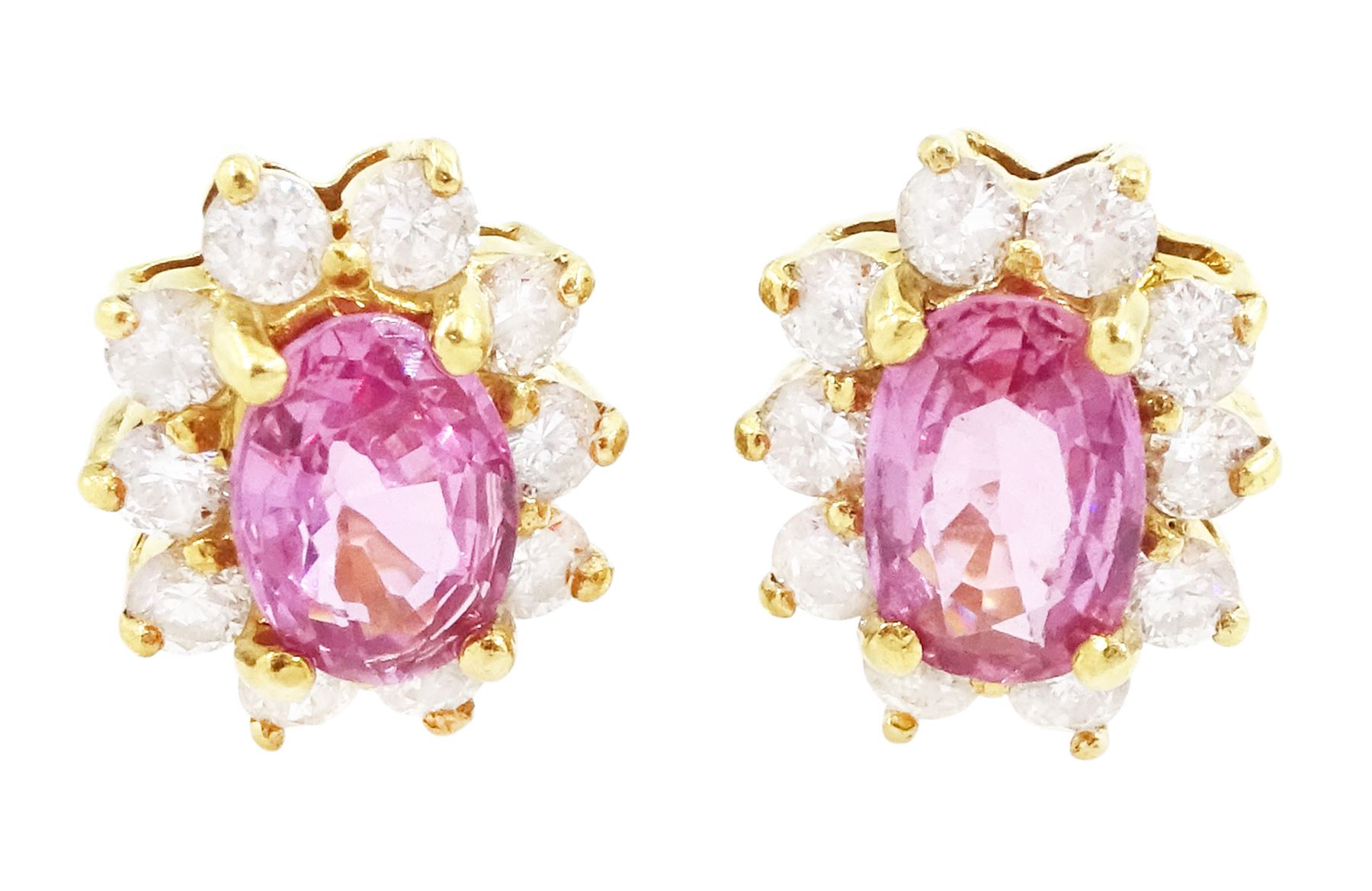 Pair of 18ct gold pink sapphire and diamond cluster earrings, each stud set with an oval cut sapphire, surrounded by ten round brilliant cut diamonds, Birmingham 2006, total sapphire weight approx 1.00 carat, total diamond weight approx 0.60 carat