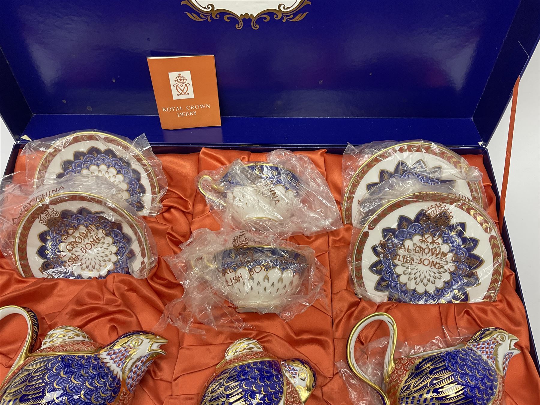 A Royal Crown Derby Quail teaset, comprising teapot, milk jug, and sucrier, all modelled in the form of quails, two cups, two saucers, and two side plates, decorated in the Imari palette, with printed marks beneath, in fitted makers box. 