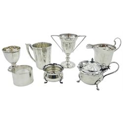 Group of assorted silver, comprising cream jug of helmet form, hallmarked Adie Brothers Ltd, Birmingham 1945, small twin handled trophy cup, hallmarked Deakin & Francis Ltd, Birmingham 1923, egg cup of circular panelled form, hallmarked Levi & Salaman, Birmingham 1918, Edwardian mustard pot and cover with C scroll rim and blue glass liner, early 20th century open salt with castellated rim, late Victorian napkin ring, and German christening mug, marked with crown and crescent, and stamped 800, approximate total silver weight 9.8 ozt (305 grams)