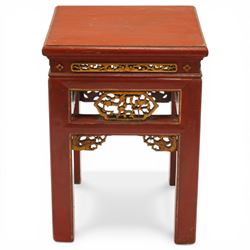 Early 20th century Chinese red lacquered occasional table, rectangular top over a pierced frieze decorated with carved giltwood floral panels and brackets, raised on moulded square tapering supports