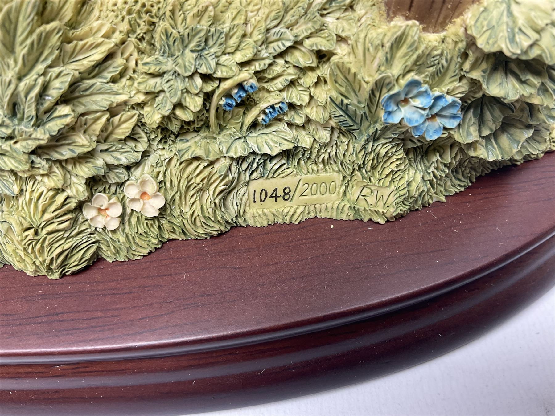 Four Border Fine Arts Beatrix Potter figures, comprising Tableau created to commemorate the Millenium together with a Border Fine Arts Limited Edition no 669814, The Tale of Peter Rabbit Tablet A1306, Four Little Rabbits A2442 and Sailing Home A2443