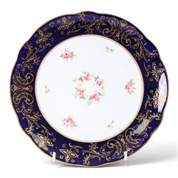 Coalport set of ten plates and four serving plates, each decorated with floral sprigs within a cobalt blue boarder with gilt detail, plates D22cm