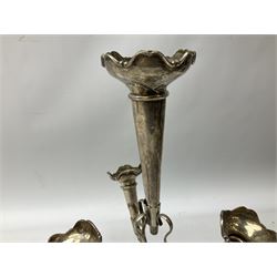 Four hallmarked silver trumpet vases, total weight 108g, upon silver plated stand with foliate decoration and bun feet