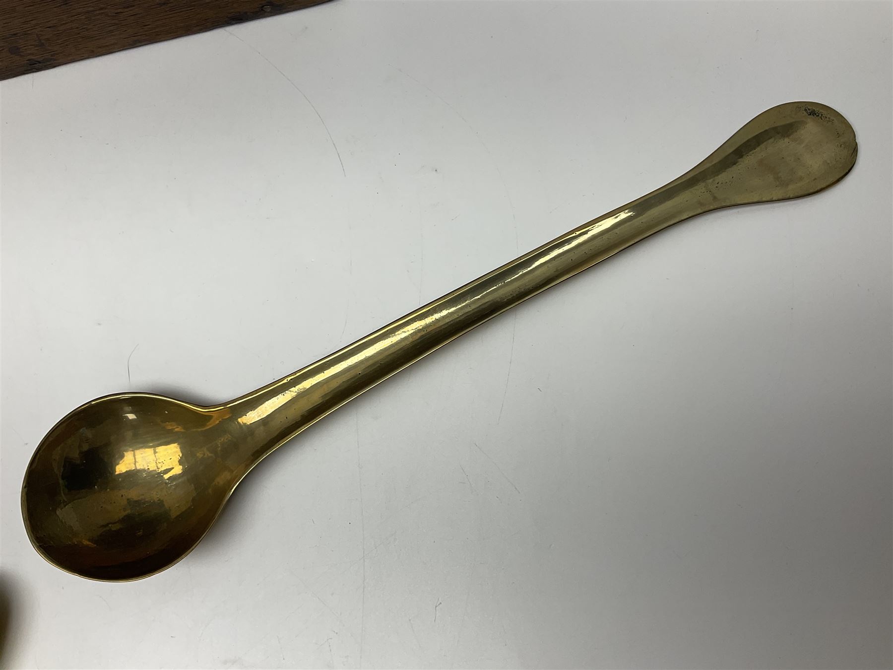 George III oak spoon rack and candle box, the rectangular backplate with shaped  pediment and two six aperture spoon racks, above a candlebox with hinged cover, with various brass spoons and a pair of brass candle snuffers, H56.5cm, W35cm, D14cm 