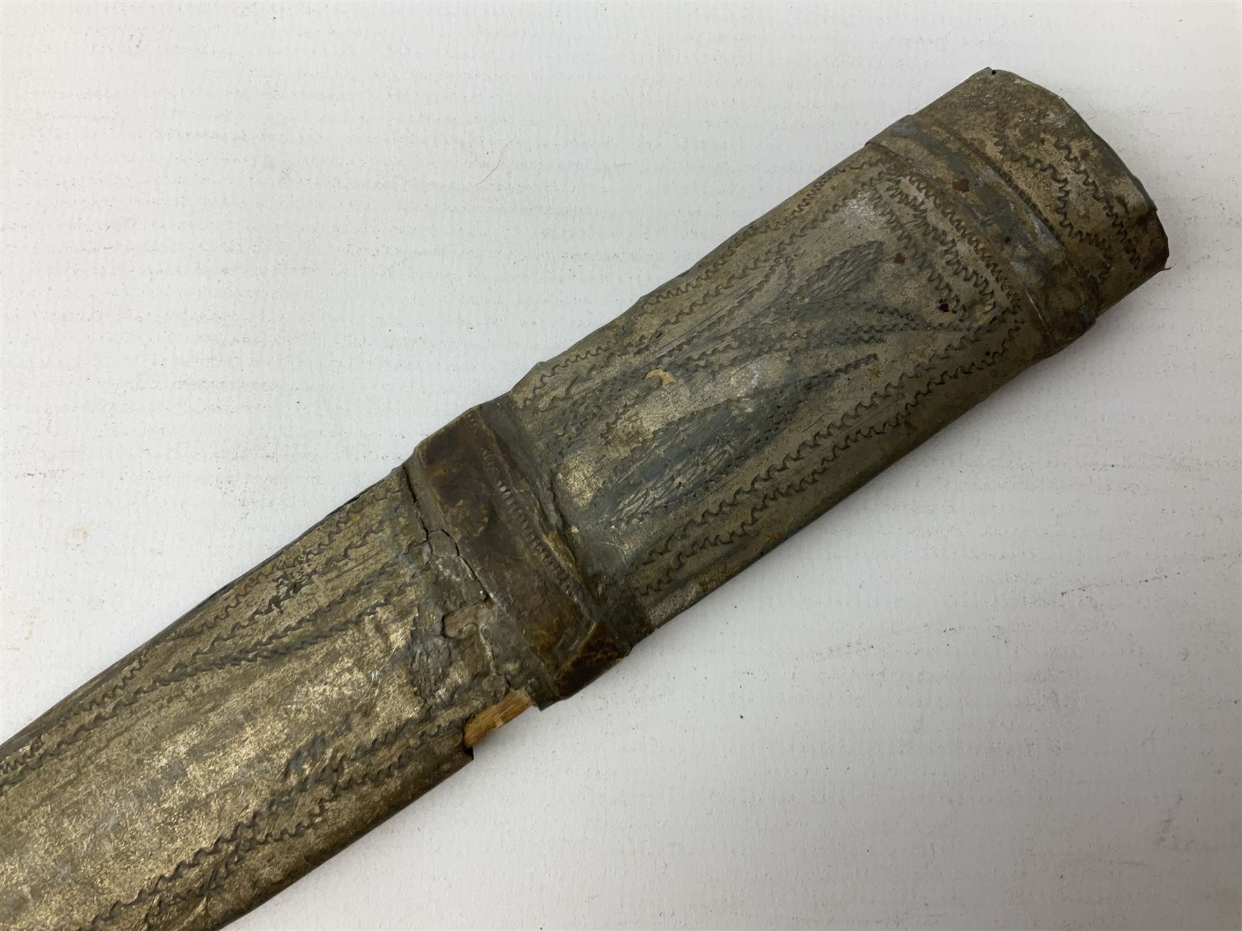 19th century Khanjali dagger, 33.5 cm double edged fullered blade with stamped makers marks, ornate cast grip, with engraved white metal scabbard, 46cm overall