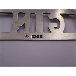 1920s silver mounted perpetual desk calendar, printed in red and black on an ivorine ground, hallmarked Charles S Green & Co Ltd, Birmingham 1925, with wooden easel style support verso, together with a set of three modern silver decanter labels, with cut-out lettering for gin, whisky and vodka, hallmarked London 1982, maker JKM, calendar H8.4cm