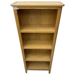Contemporary light oak open bookcase, fitted with three shelves, on tapering supports