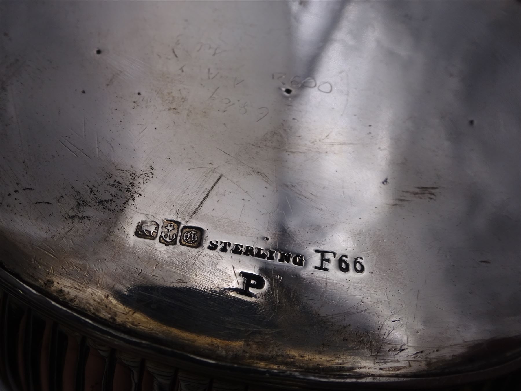 1930s American silver three piece batchelors tea service, comprising teapot, twin handled open sucrier and milk jug, each of part fluted oval form, the teapot with personal engraving to body, wood effect handle and silver urn shaped finial, stamped sterling with maker's mark for Gorham, teapot H13cm