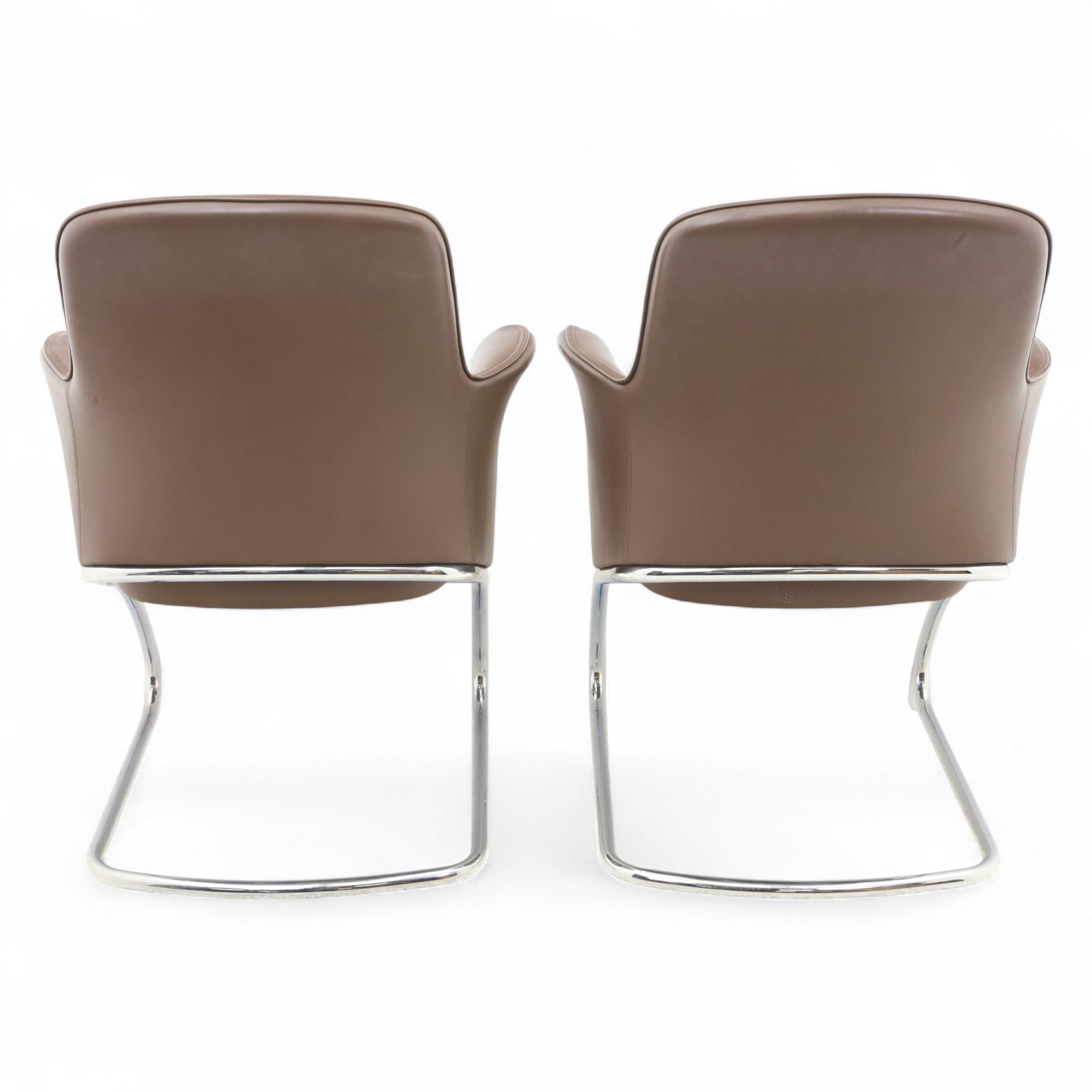 Two Senator executive cantilever chairs, upholstered in Padova hide, moulded back and integrated armrests, raised on a tubular chromed cantilever base