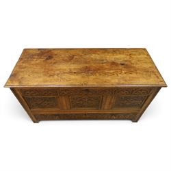 18th century carved oak coffer, rectangular hinged top over a lunette-carved frieze and tracery-style carved triple panelled front, the lower rail carved with repeating anthemion motifs, on square feet