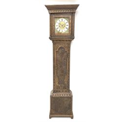 19th century carved oak longcase clock, projecting cornice over guilloche carved frieze, square brass dial with silvered Roman chapter ring and calendar aperture, decorated with ornate mask cast spandrels, the trunk door and base carved with potted plant, twin train driven eight day movement striking on bell