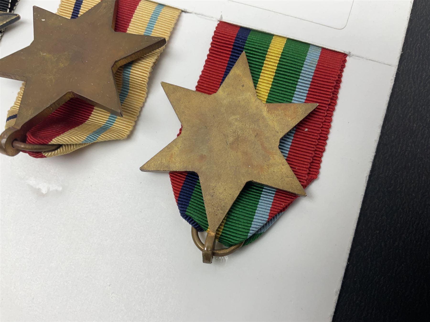 Representative display of WWII Campaign stars comprising 1939-1945 Star, Atlantic Star, Air-Crew Europe Star, Africa Star and Pacific Star; together with the corresponding group of miniatures; all with ribbons
