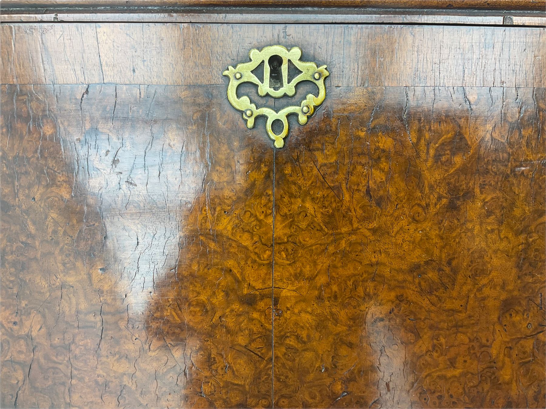 Small early 20th century Queen Anne style bookcase on bureau secretaire, the moulded arched pediment over mirrored door in shaped frame, the bureau fitted with fall front enclosing curved fitted interior, cushion moulded drawer over single drawer, on scroll and shell carved cabriole supports