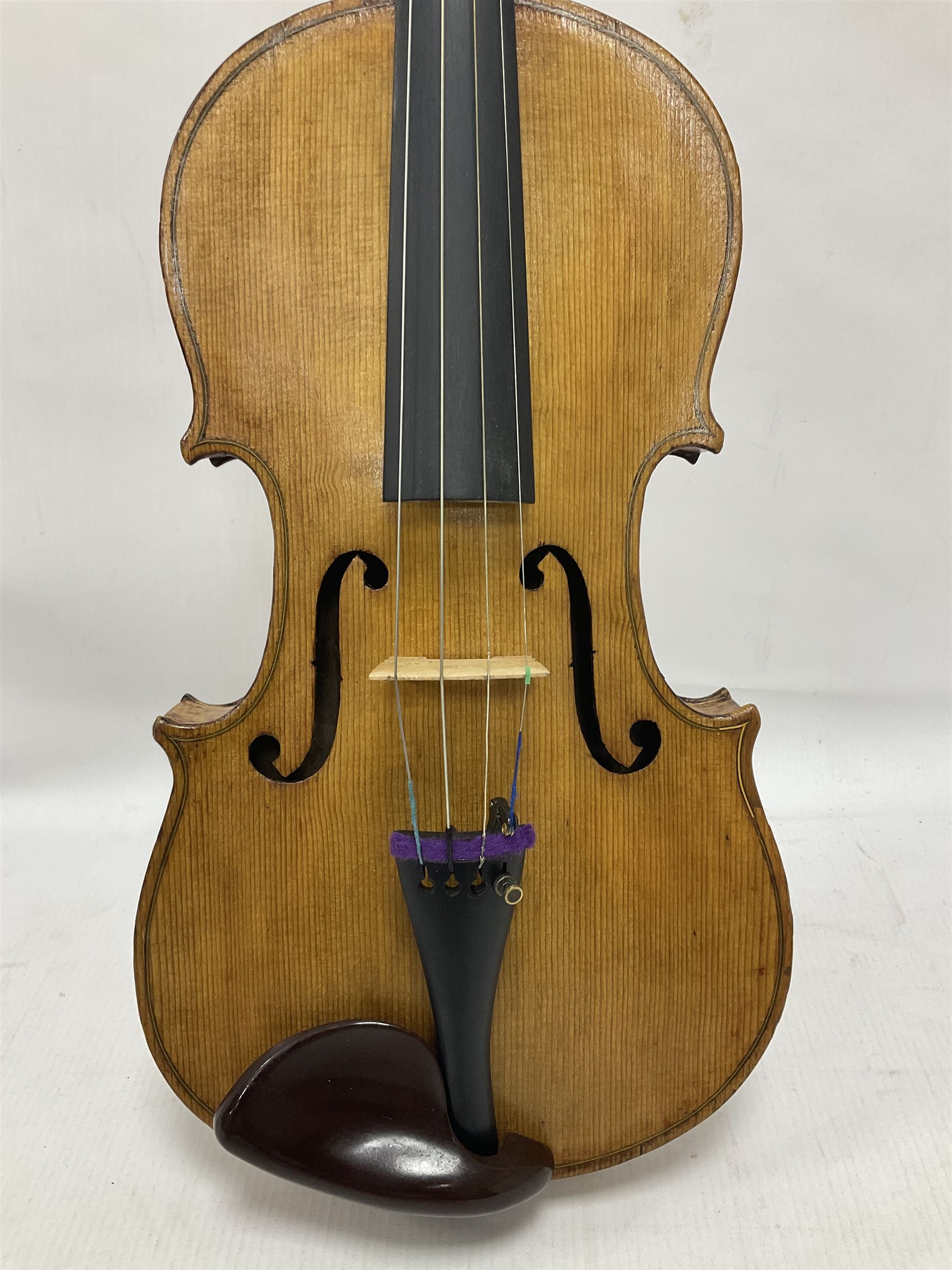 Copy of a full size Stradivarius violin, with an ebonised fretboard, tailpiece and tuning pegs, with a polished chin rest  Length 60cm