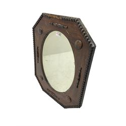 Early 20th century oak framed wall mirror, chamfered corners with beading border, oval bevelled plate