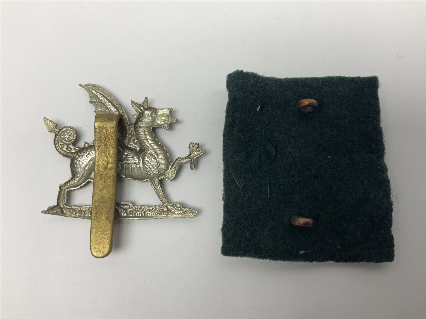 Fourteen cap badges of Irish interest including Royal Dublin Fusiliers inscribed to the slider 'From A. O'Connor 2nd Batt. Dec.2nd 1915', Connaught Rangers, South irish Horse Yeomanry, Inniskilling Fusiliers, Royal Irish Regiment etc; and seven Welsh badges including South Wales Borderers, Welsh Guards, 3rd Bn. Monmouthshire Regt. etc (21)