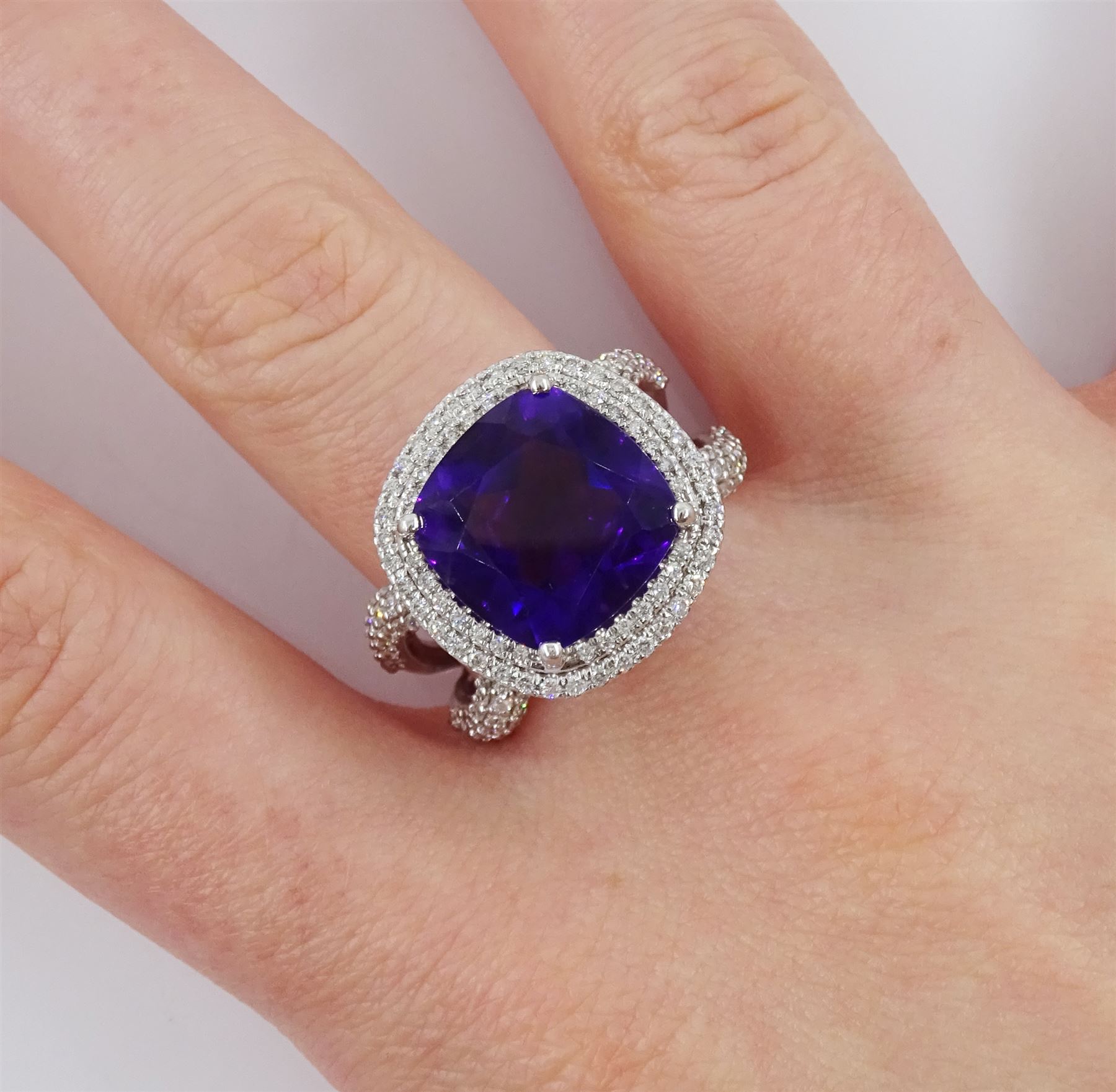 Damas 18ct white gold amethyst and diamond Vera ring, the central square cushion cut amethyst of 6.28 carat, with round brilliant cut diamond surround, pear cut amethyst gallery and diamond set shoulders, total amethyst weight 15.48 carat, total diamond weight 1.10 carat, with certificate