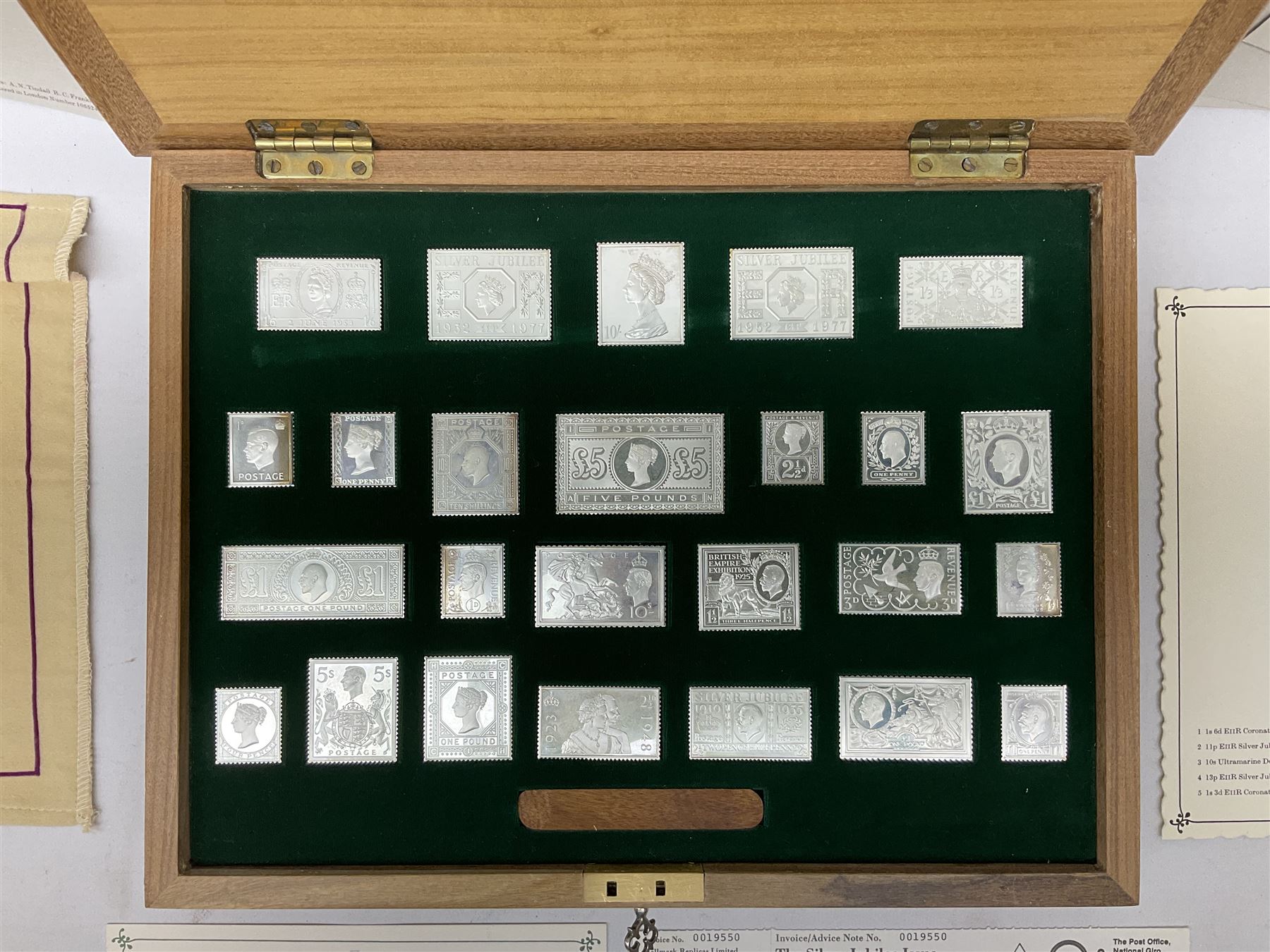 The Stamps of Royalty collection consisting of twenty-five sterling silver hallmarked stamp replicas, housed in a fitted wooden display case, with certificates, polishing cloth and certificates