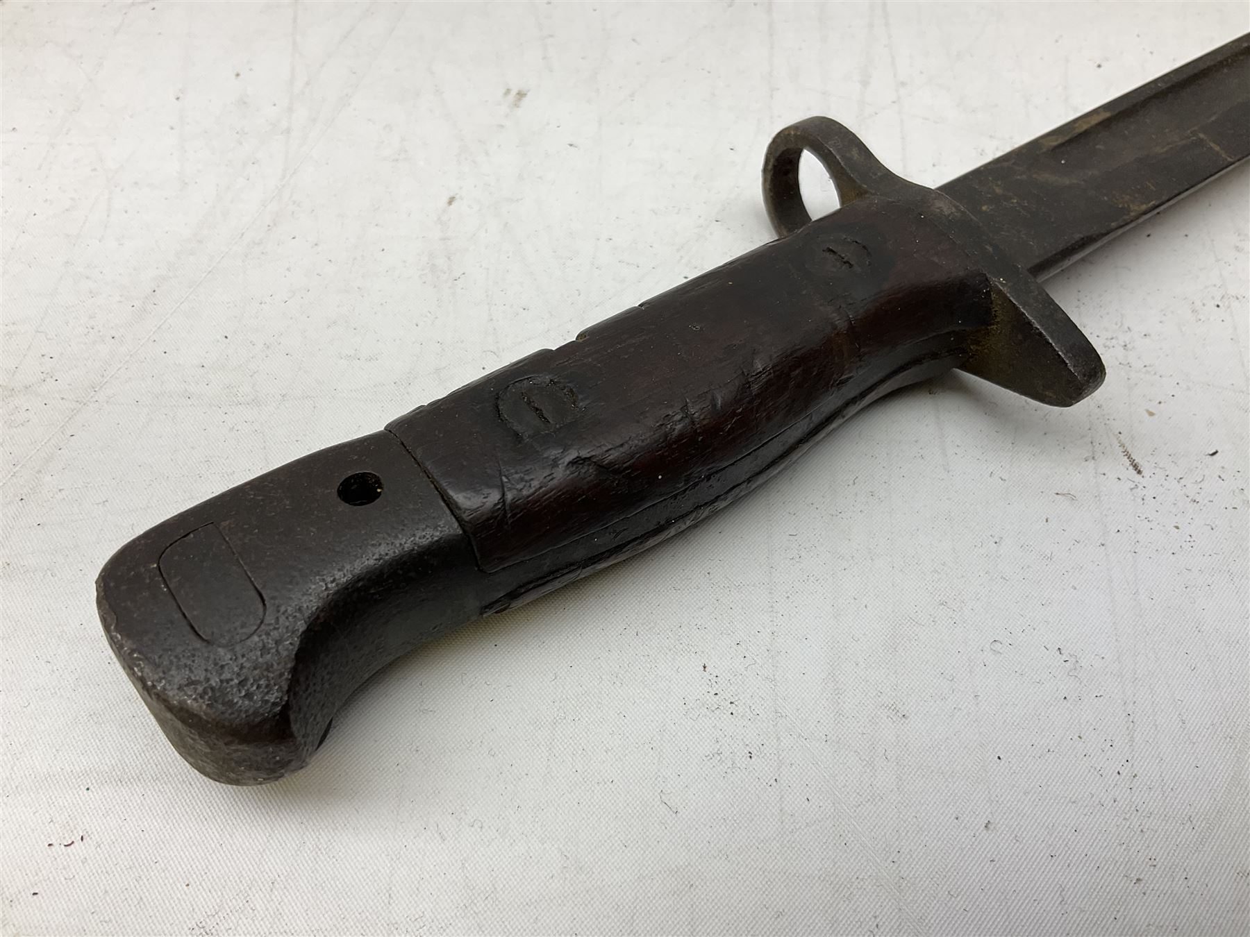 British Pattern 1907 bayonet with 43.5cm fullered steel blade; in leather scabbard with webbing frog L58cm overall; another Pattern 1907 bayonet lacking scabbard; and British Pattern 1888 Mk.I bayonet by Wilkinson London (no scabbard) (3)