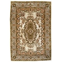 Persian ivory ground rug, the central olive medallion surrounded by foliate branches and a waived spandrel border, guarded border with interlaced flower heads and scrolls
