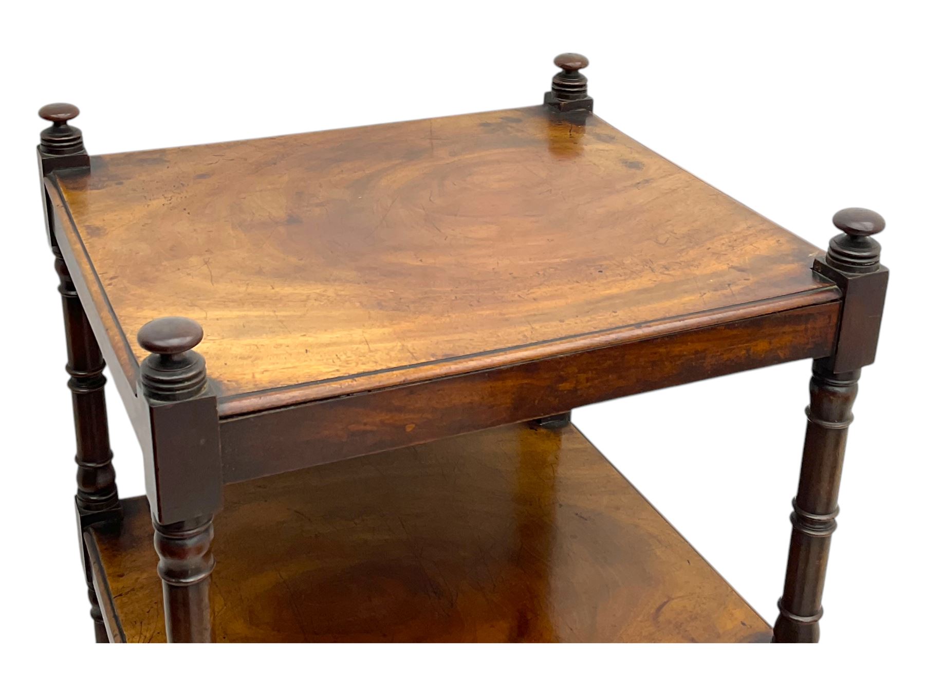 Early 19th century mahogany whatnot, with four rectangular shelves, the lower shelf fitted with a single drawer, supported by slender turned columns, raised on turned supports with brass castors