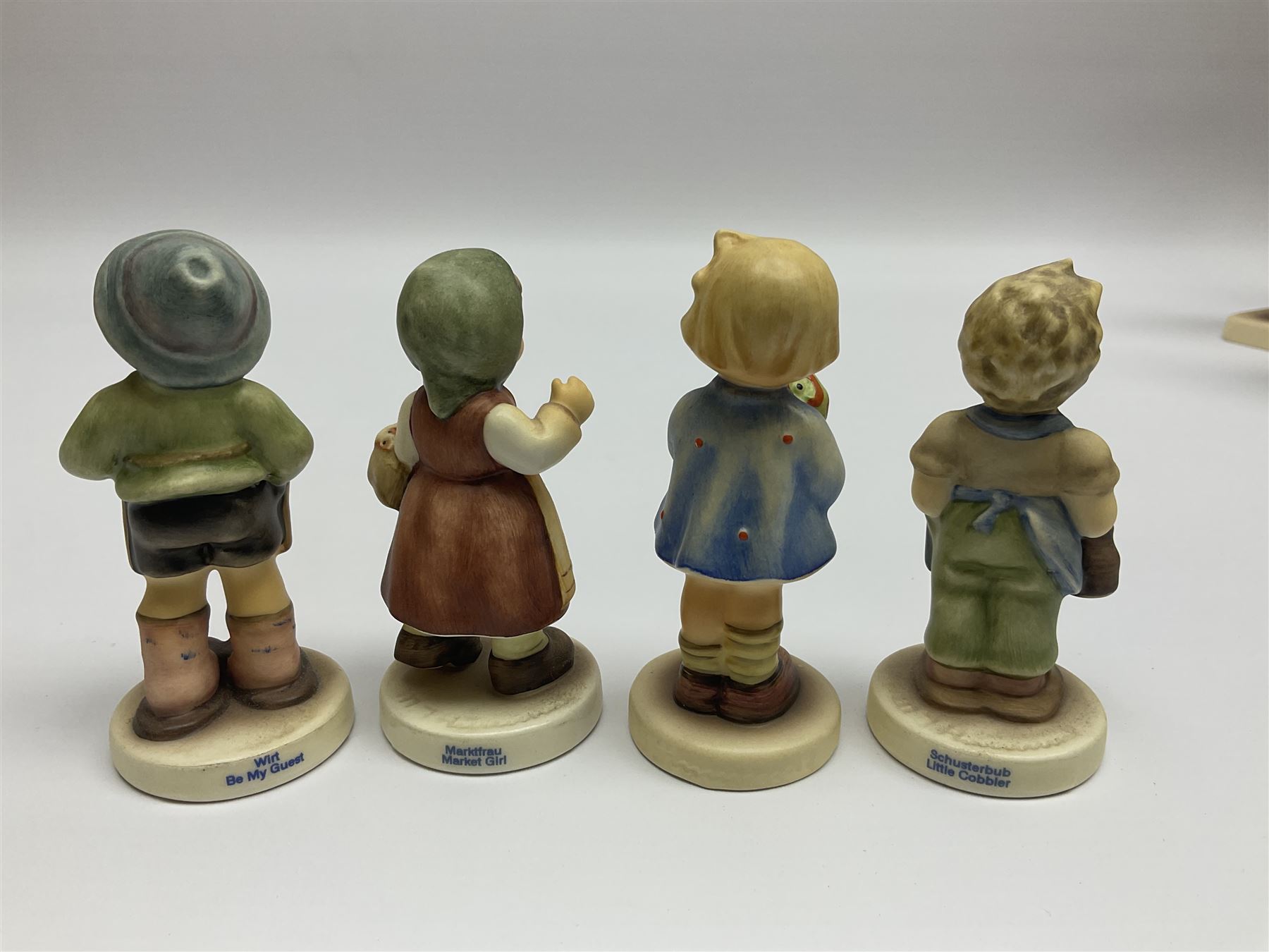 Thirty Hummel figures by Goebel, to include Saluting the Peacekeepers of Operation Joint Endeavor, on wooden plinth, Call to Glory, Celebrate with Song and Soldier Boy